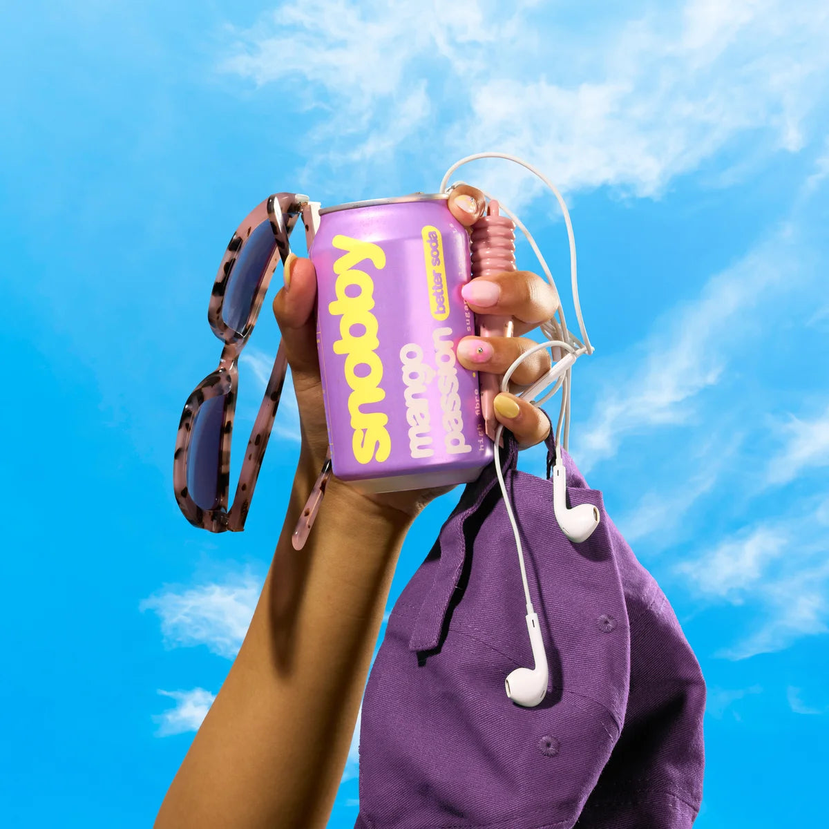 can held in hand against a blue sky, for scale