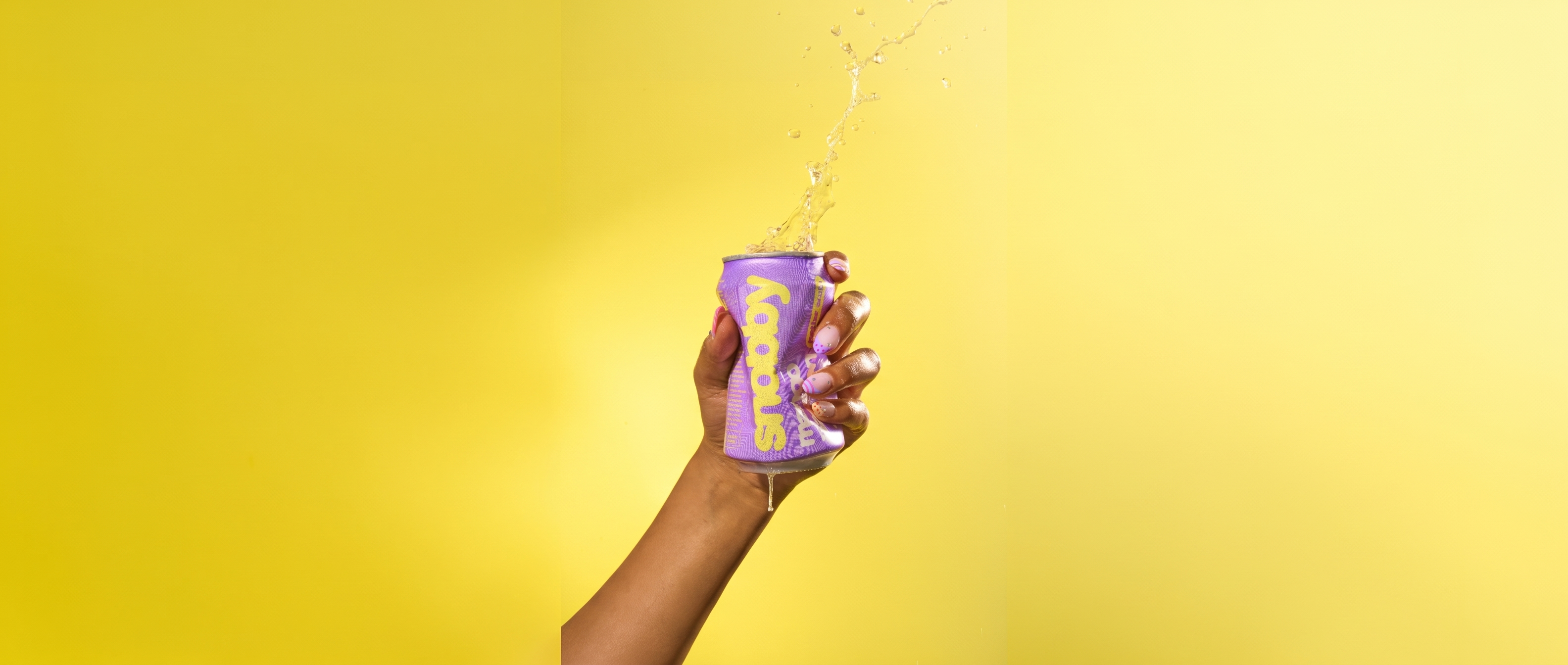 hand holding a snobby mango passion can with a splash