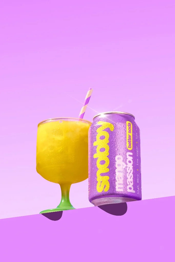 snobby mango passion can next to a poured glass